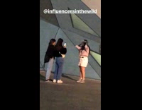 Girl takes picture with triangle building 