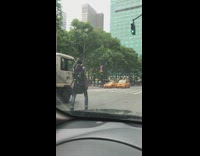 guy in black back pack skipping through street