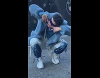 Guy blue coat sit point his teeth