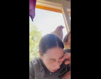 Chicken stands on shoulder and pecks womans eyelid 