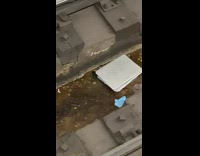 Broken laptop on subway tracks drainage tube