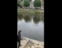 Guy throw rock sideways bounce across river
