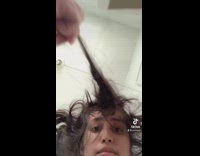 Girl pulling chunks of hair off of her head 