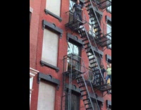 Man performs at fire escape during party