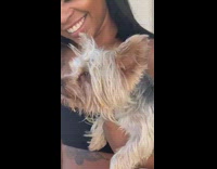 Girl holds small dog howls siren smoke 