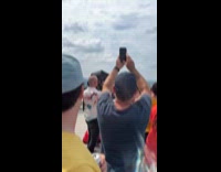 People on building saw jet pass by