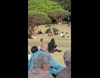 Blue shirt guy jump flip crowded park