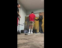 Three guys try to kill mouse with fire spray, rat escapes bucket and runs away from garage