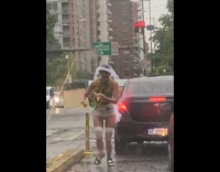 Woman veil underwear walk middle street rain