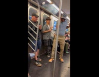 Man dancing inside subway train
