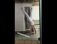 girl in white doing handstand on subway station