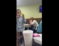 Kid puts bird on peoples head at restaurant