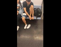 Collab Subway Creatures - Man black shirt puts bandage on feet at train