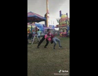 Two guys interlock arms make human wheel 