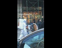 Astronaut walks among pedestrians crossing the street 