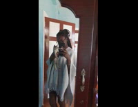 Kitten held by owner in mirror while on camera