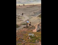 Blue sweater orange pants girl beach sunset