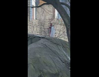 Guy covered in red paint poses rock 