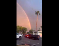 Double rainbow with lighting on parking lot