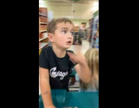 Collab PubityPets - Boy points and demands on the car push cart in the supermarket