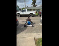 Guy falls off gokart in street