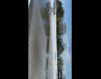 Girl throws ice across frozen lake 