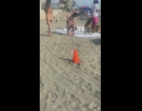 Woman in bikini flexes butt while man takes picture