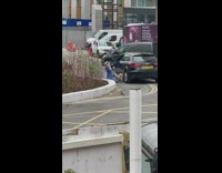 Woman three feet lay ground beside car
