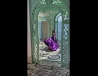 Woman emerges from the violet dress of another woman