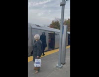 Guy walks out of train in helmet costume 