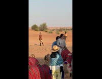 Collab IITW - Woman in brown dress and black boots poses at the desert