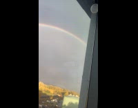 Filmer show double rainbow on sky