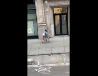 Man wears white wings walk on street