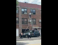 Man climb ladder on top of car roof