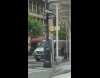 Guy does pull ups on corner traffic light