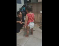 Guy stacking jenga tower and then toddler knocks it over