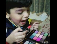Collab KidsDT - little boy with bowl cut putting on make up