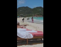 Woman in red heels poses at the beach shore