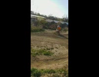 Orange sweater kid red dirt bike ramp 