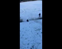 Man slides downhill on a sled and fell down
