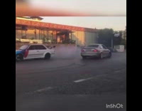 Two cars almost hit each other donuts