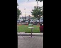 Man spins around on spinning platform while holding dumbbells in each hand