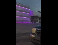 Influencer poses in front of gym lights 