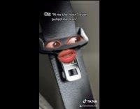 Girl acts like car seatbelt and buckle 