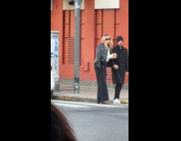 Woman jacket with tag poses at street