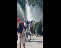 Man on bike with orange safety cone
