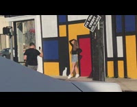 Girl posing in front of rectangle mural wall