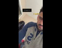 Guy in blue 5 jacket throws hat behind his back and hangs it on coat rack