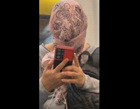 Woman wears scarf around head 