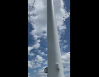 Person underneath a large windmill blades spin